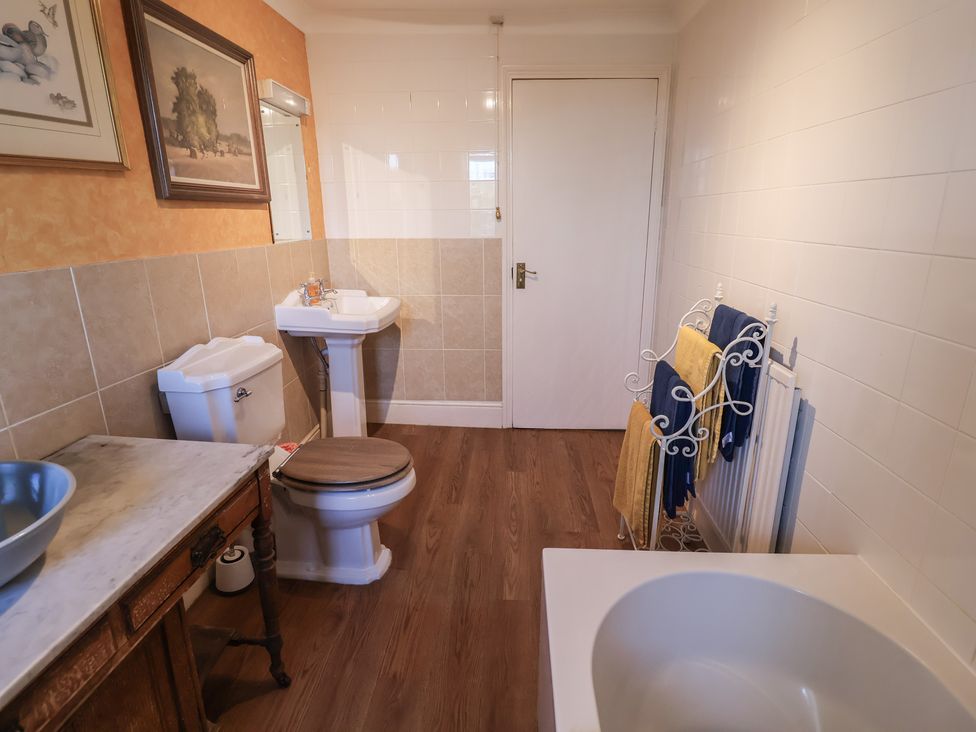 A bathroom with a toilet and wash basin at Farmhouse in Beccles