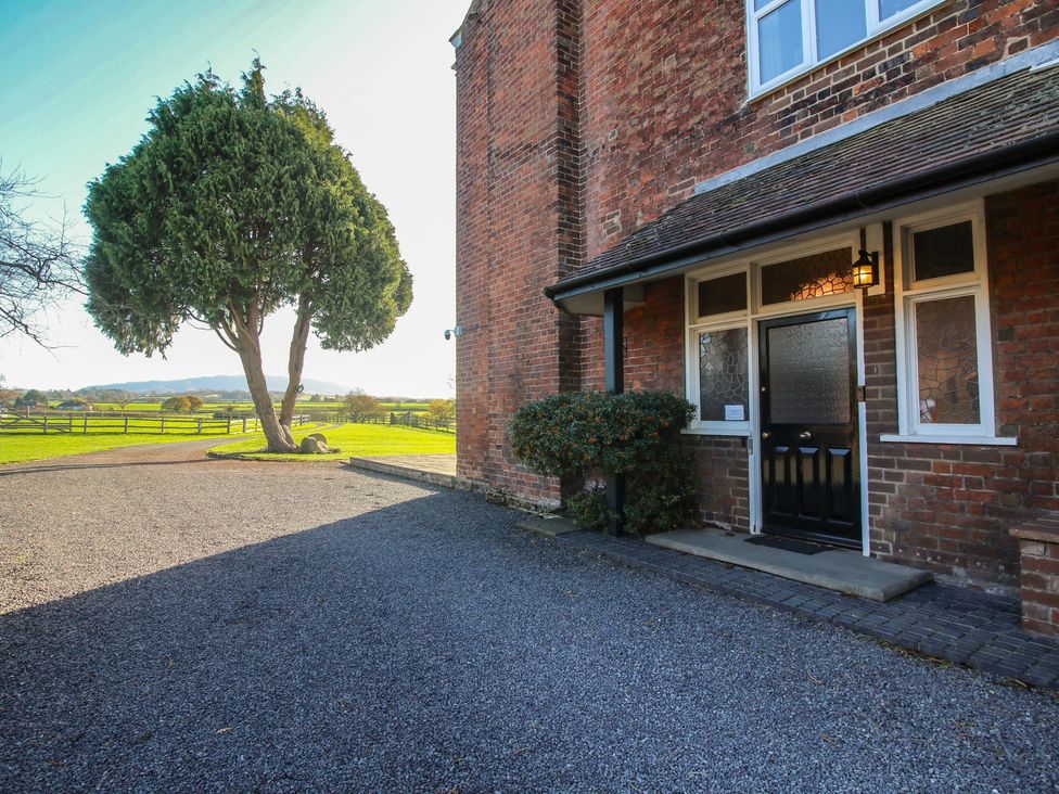An outdoor view of a house entrance with a gravel driveway at The Mill House in 