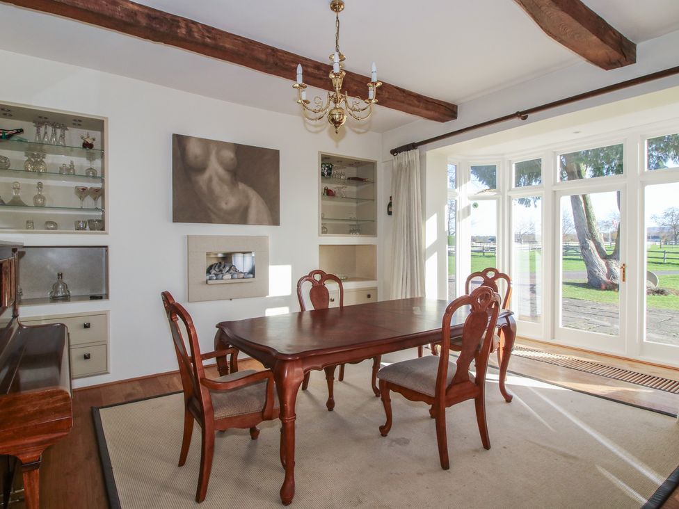 A dining room with a table and chairs at The Mill House in 