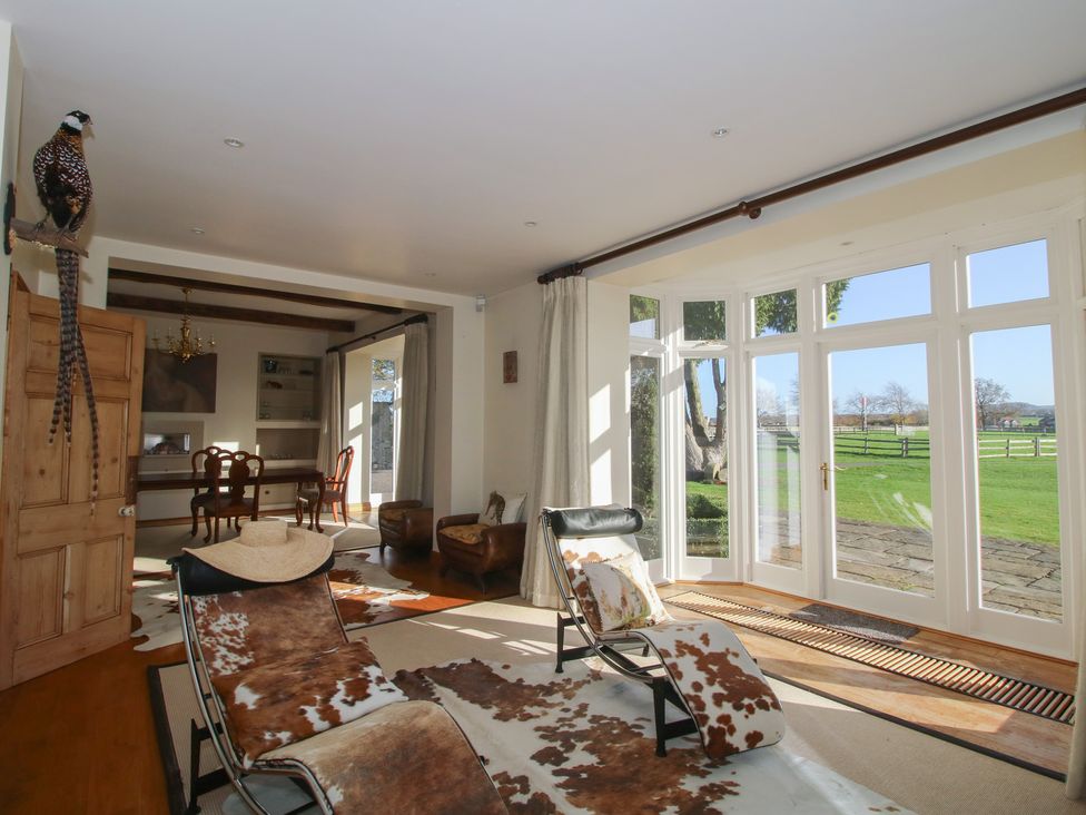 A living room with a chair and table at The Mill House