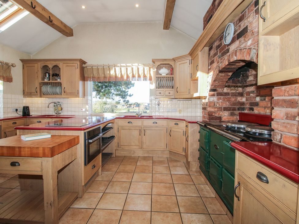 A kitchen with cabinets, countertop, and appliances at The Mill House in 