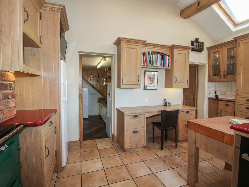 A kitchen with a countertop and cabinetry at The Mill House 
