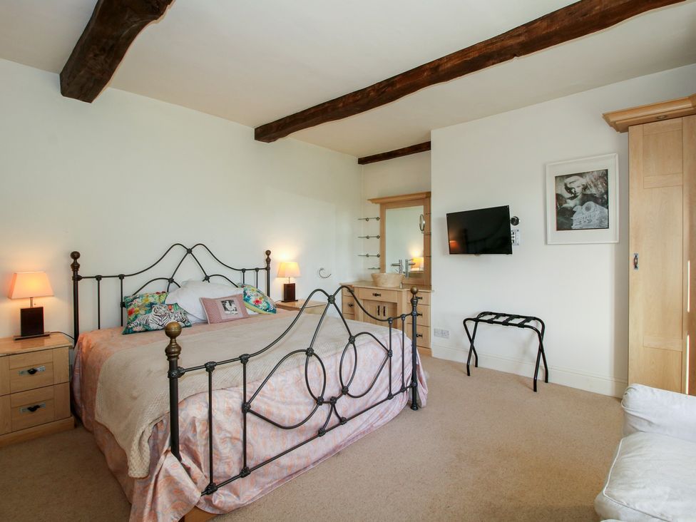 A bedroom with a bed and lamp at The Mill House