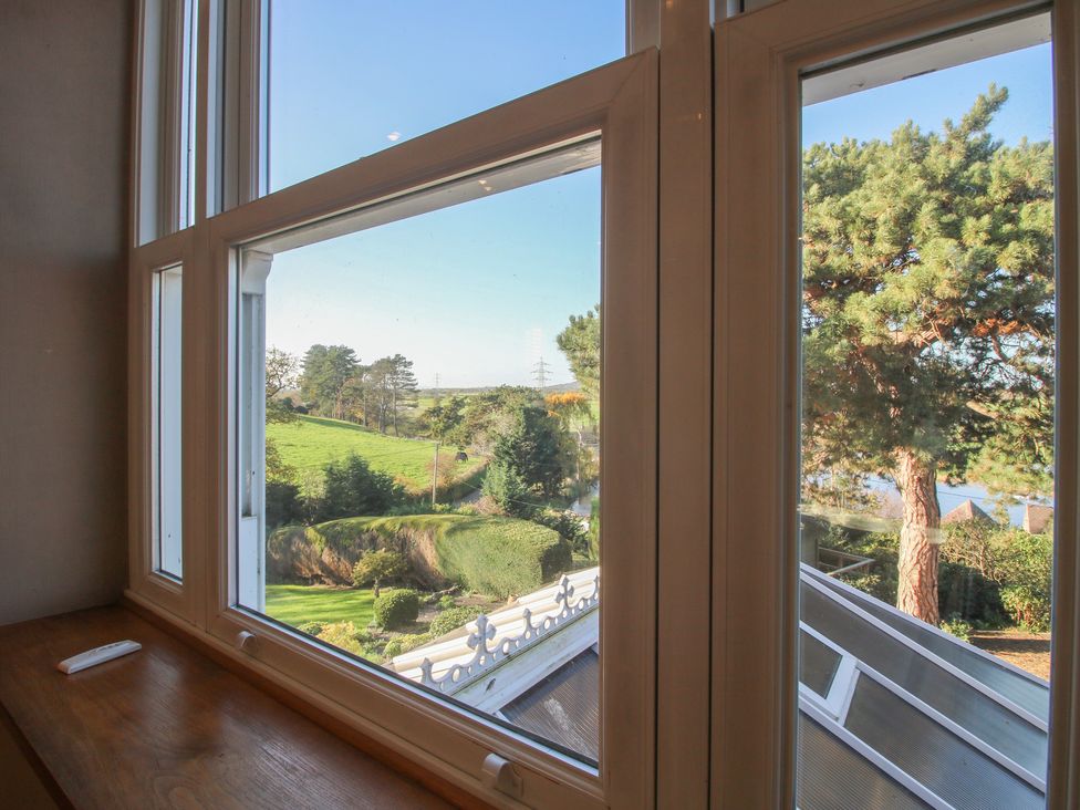 A view from a window showing a landscape and trees at The Mill House 