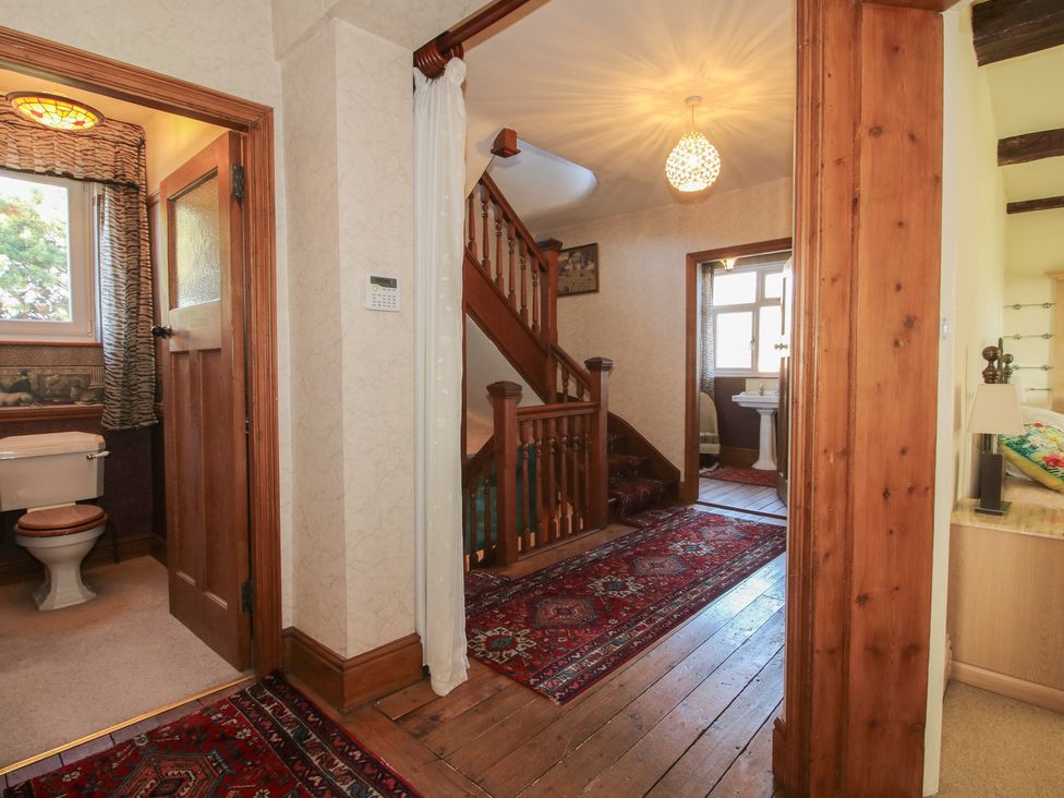 A hallway with stairs and a toilet at The Mill House in 