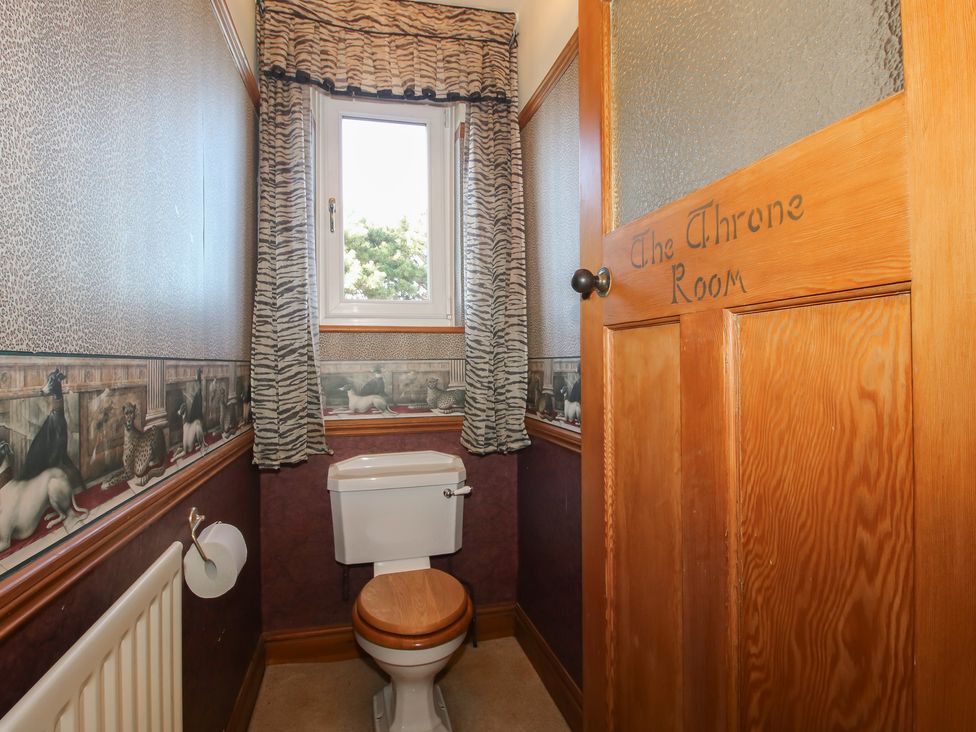 A bathroom with a toilet and window at The Mill House
