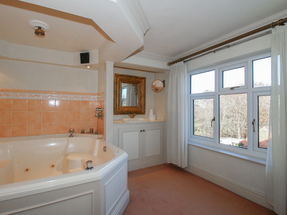 A bathroom featuring a bathtub and window at The Mill House 