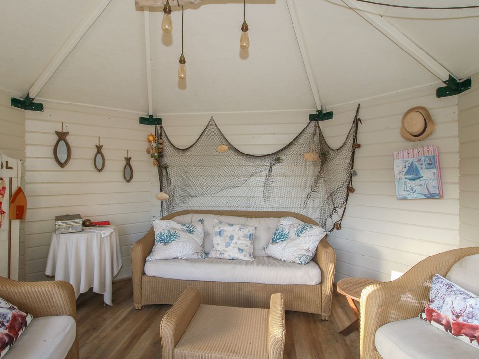 A snug with seating and decorations at The Mill House in 