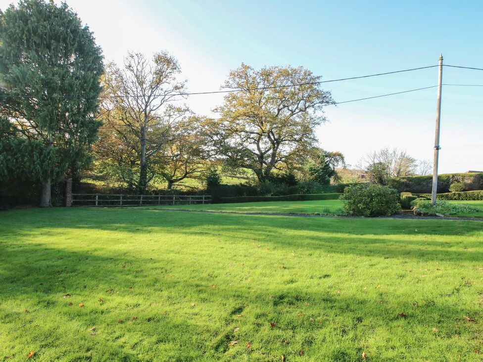 An outdoor area with grass and trees at The Mill House