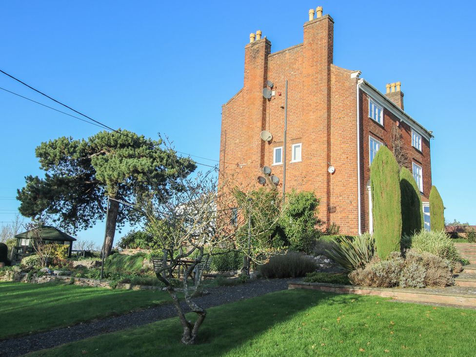 A house and garden with trees and a pathway at The Mill House in 