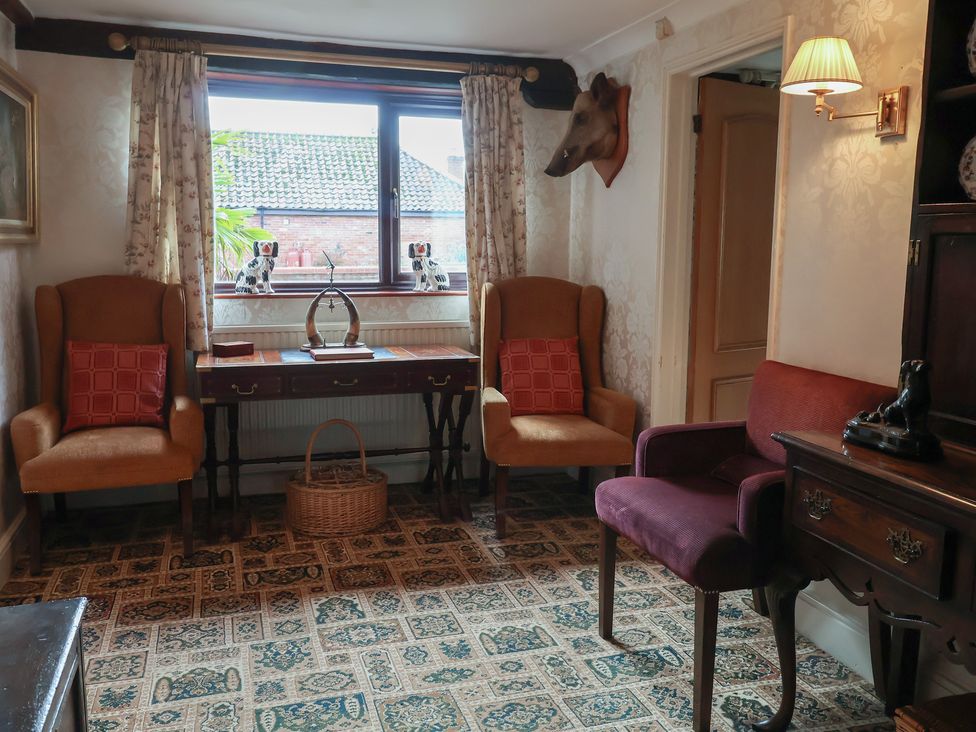 A snug with chairs and a table at Winston Lodge in Beccles