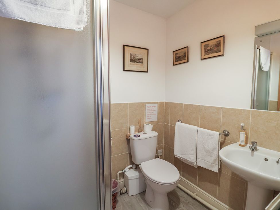 A bathroom with a toilet and sink at Winston Lodge in Beccles