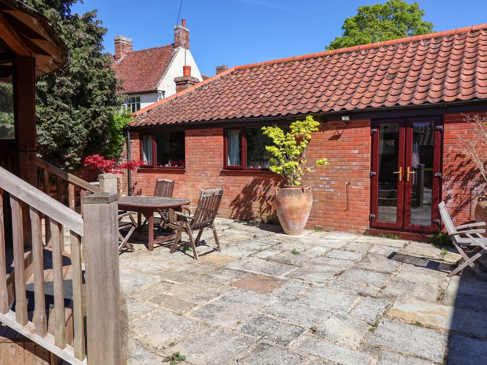 An outdoor patio with a table and chairs at Winston Lodge in Beccles