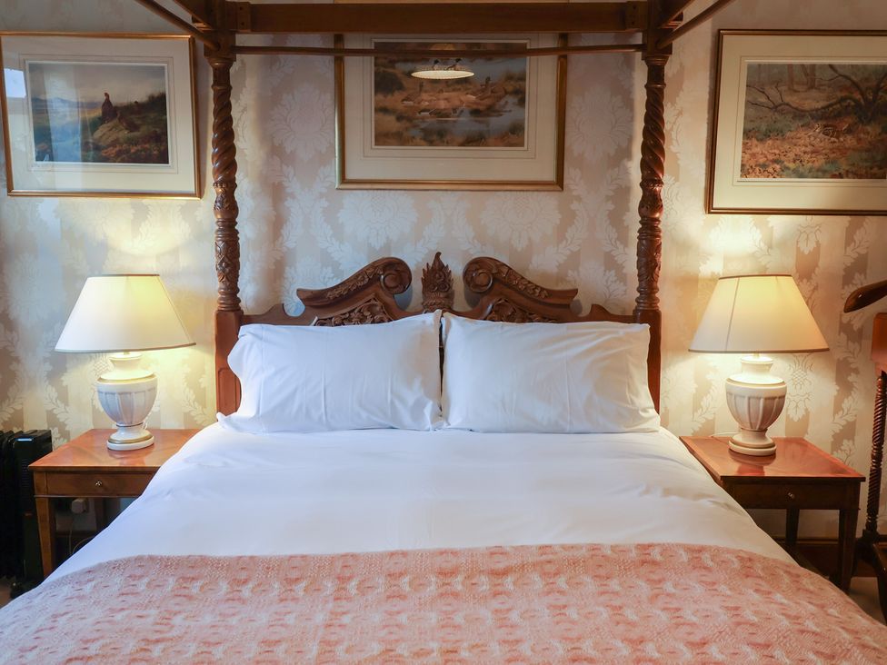 A bedroom with a bed and bedside tables at The Gun Room in Beccles