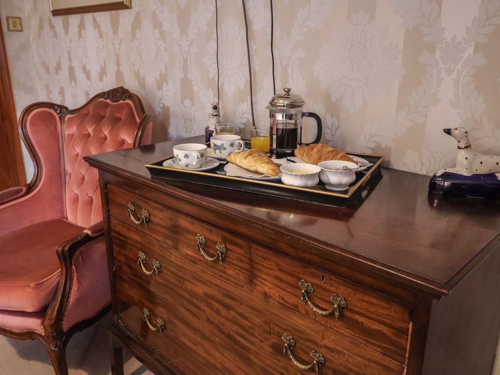 A dining room with a tray of food on a chest of drawers at The Gun Room in Beccles