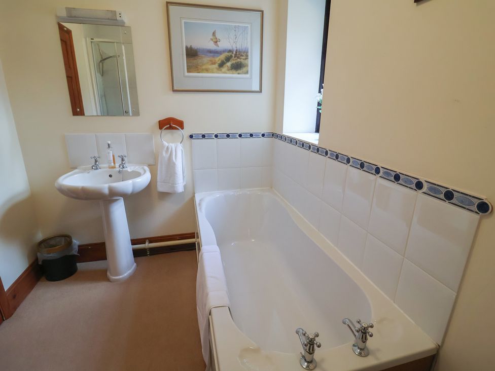 A bathroom with a bathtub and sink at The Gun Room in Beccles