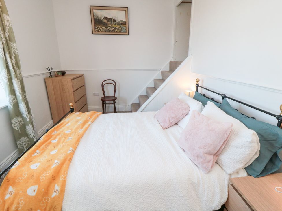 A bedroom with a bed and a chest of drawers at Cattersty Cottage