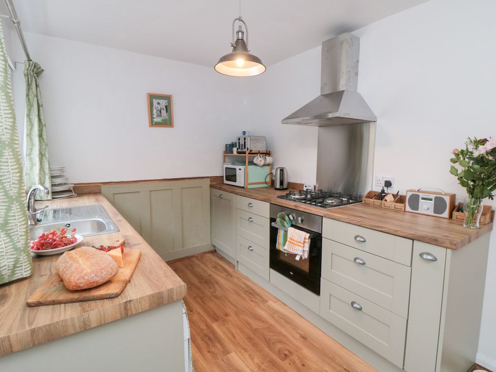 A kitchen with a cooking range and sink at Cattersty Cottage 