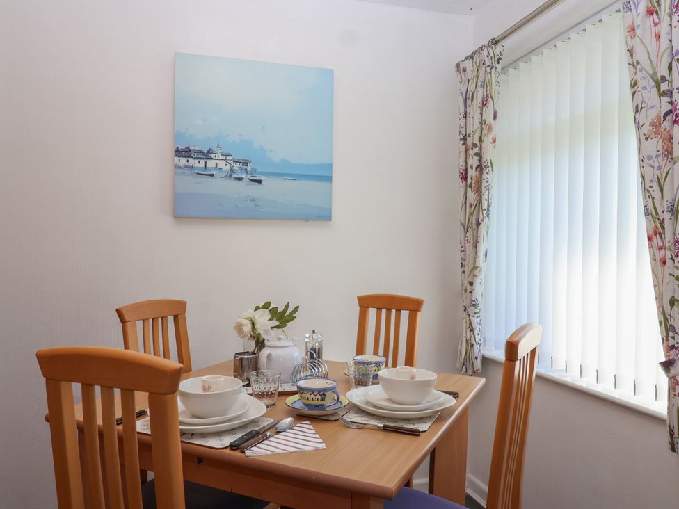 A dining room with a table set for meals at Westview in Liskeard