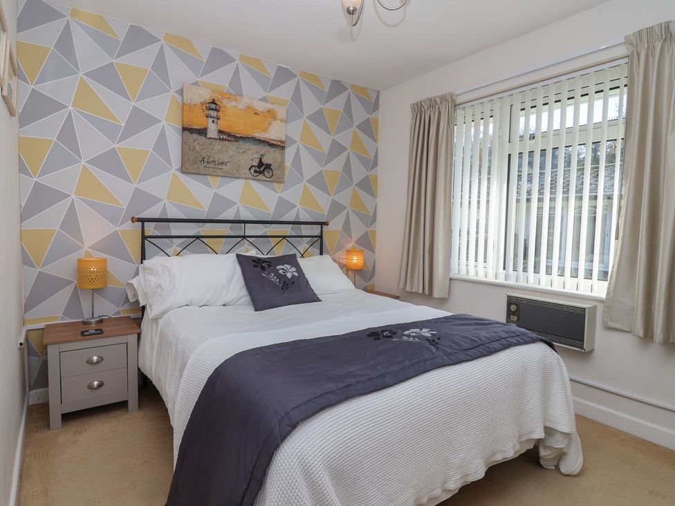 A bedroom with a bed and nightstand at Westview in Liskeard