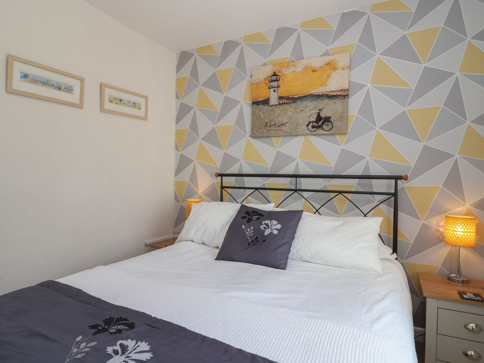 A bedroom with bed and wall art at Westview in Liskeard