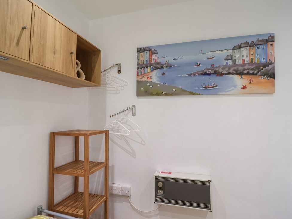 A utility room with cabinets and shelves at Westview in Liskeard
