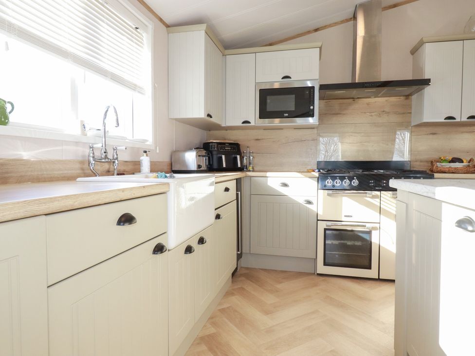 A kitchen with cabinets, a sink, and appliances at FW4 (Fairways 4)