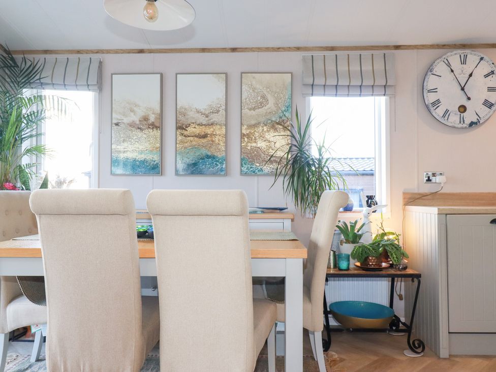 A dining room with a table and chairs at FW4 (Fairways 4)