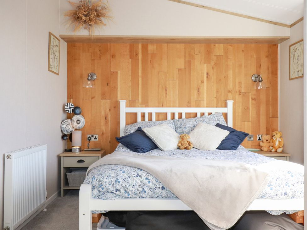 A bedroom with a bed and nightstand at FW4 (Fairways 4)