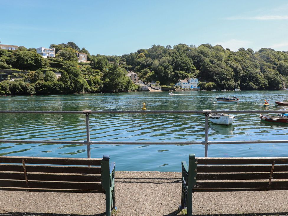 A view of water with boats and houses from a bench at FW4 (Fairways 4) Doublebois near Dobwalls