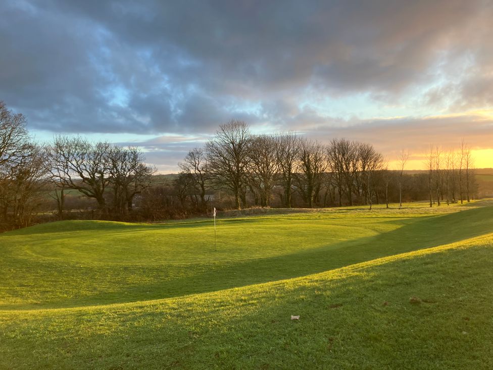 A golf course with a flag and trees at FW4 (Fairways 4) Doublebois near Dobwalls