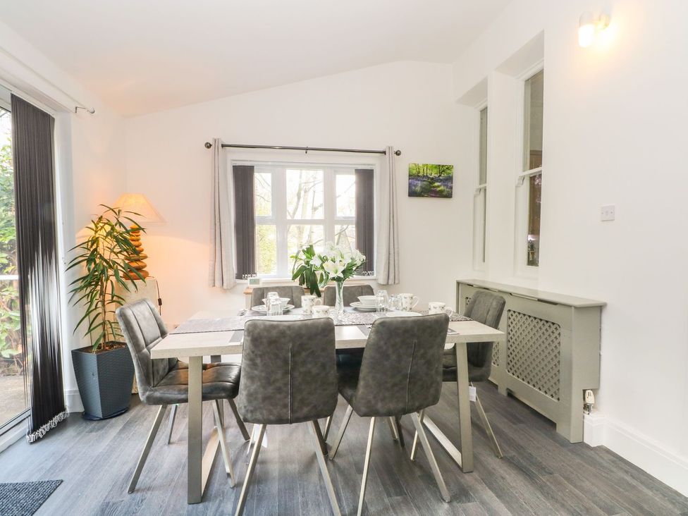 A dining room with a table and chairs at Beechwood House Hadfield
