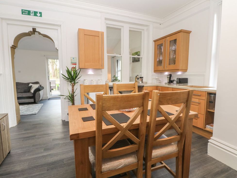 A kitchen with dining table and chairs at Beechwood House Hadfield