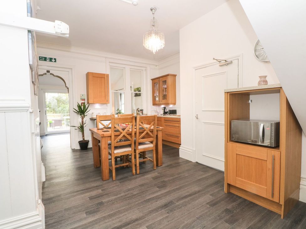 A kitchen with a dining table and chairs at Beechwood House Hadfield
