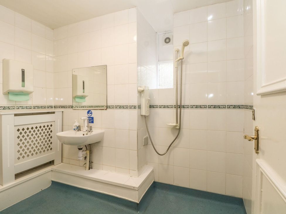 A bathroom with a sink and a shower at Beechwood House in Hadfield