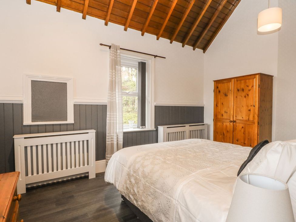 A bedroom with a bed and window at Beechwood House in Hadfield