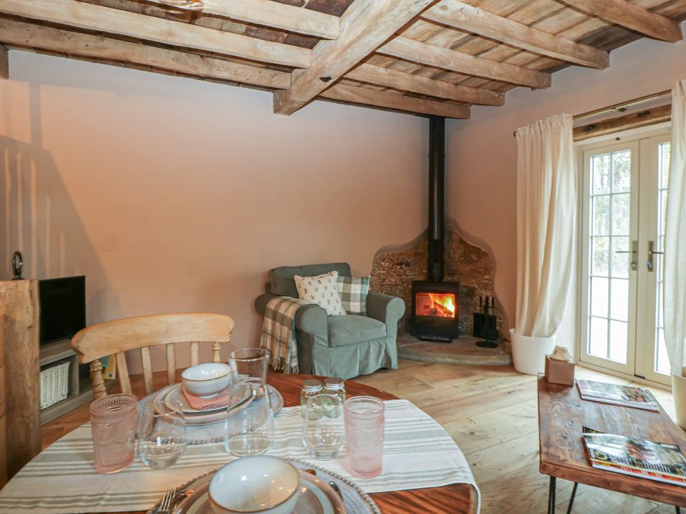A living room with a sofa and fireplace at The Cow Shed in Ross-on-Wye