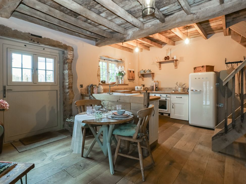 A kitchen with a table and chairs at The Cow Shed in Ross-on-Wye