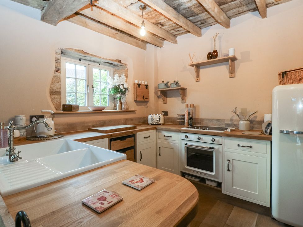 A kitchen with a sink and oven at The Cow Shed in Ross-on-Wye