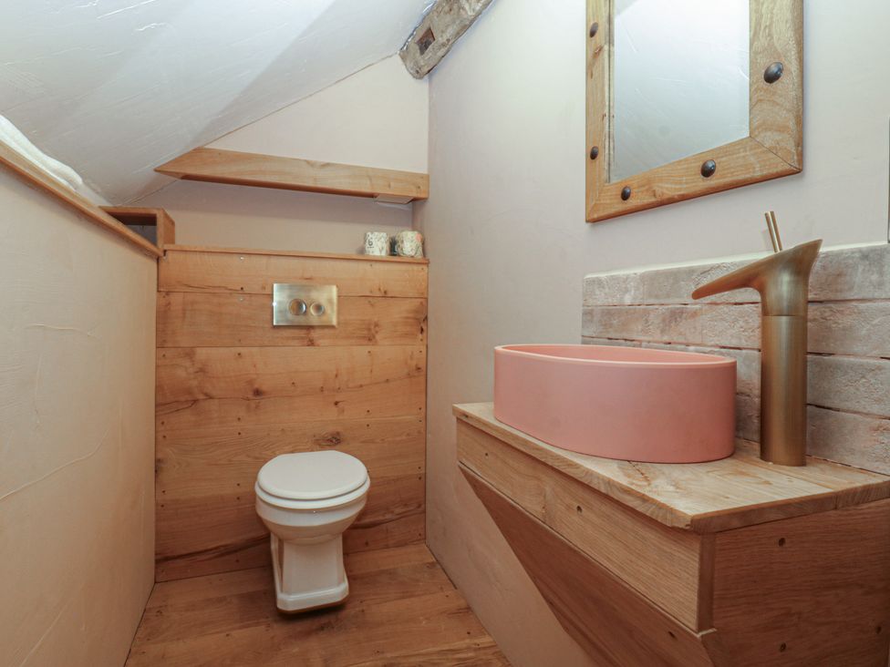 A bathroom with a toilet and sink at The Cow Shed in Ross-on-Wye