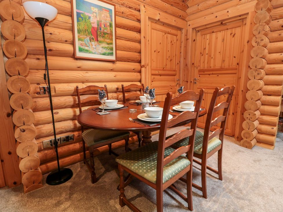 A dining room with a table and four chairs at Little Bears Hideaway @ 23 Lakeside, Felmoor Park near Felton