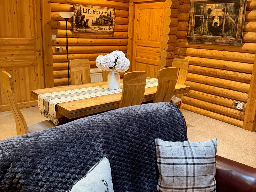 A dining room with a wooden table and chairs at Little Bears Hideaway @ 23 Lakeside Felmoor Park near Felton