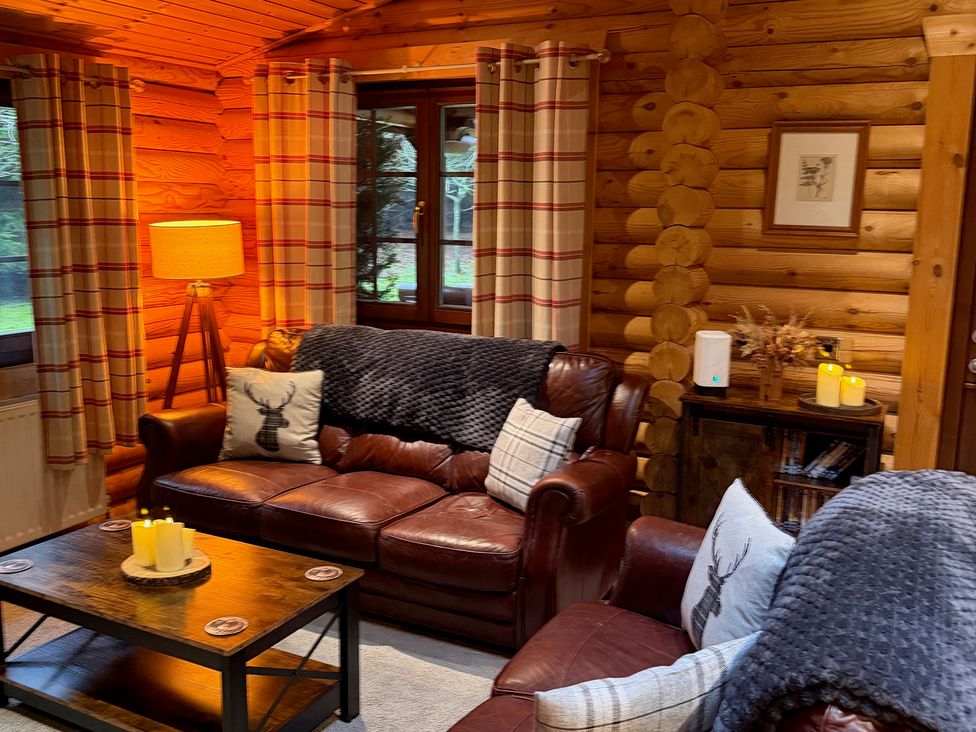 A living room with a sofa and coffee table at Little Bears Hideaway @ 23 Lakeside Felmoor Park near Felton