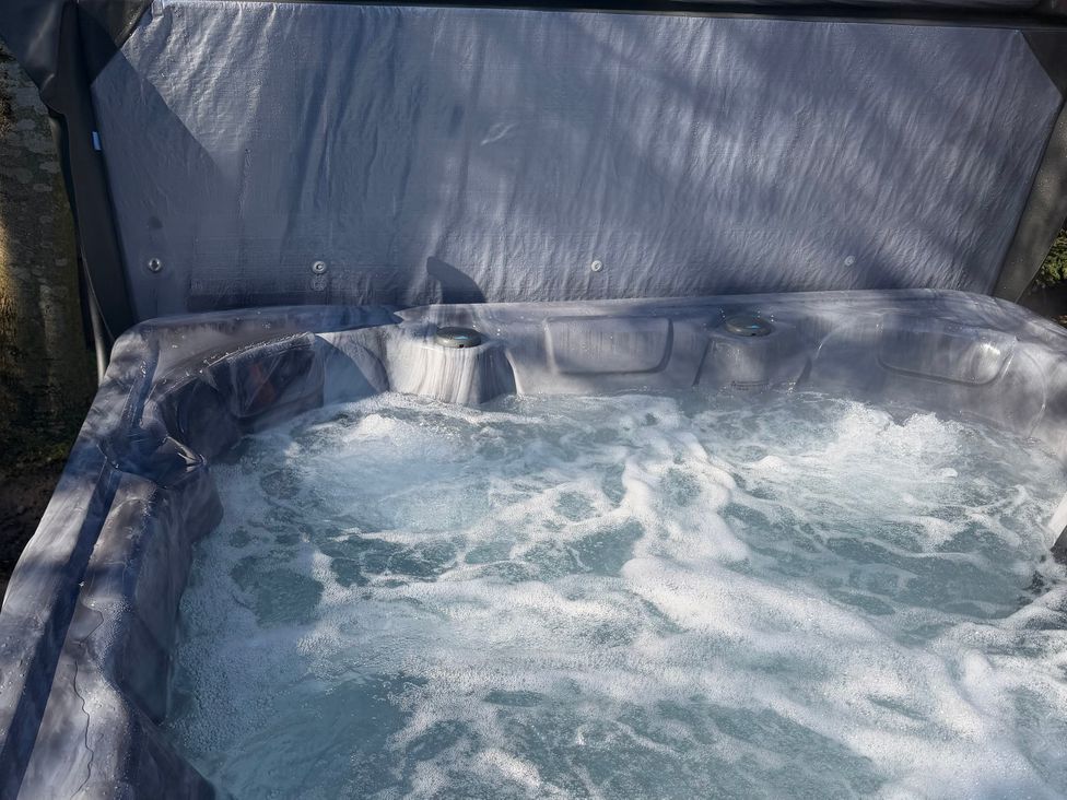 A hot tub with bubbles and water at Little Bears Hideaway @ 23 Lakeside Felmoor Park near Felton