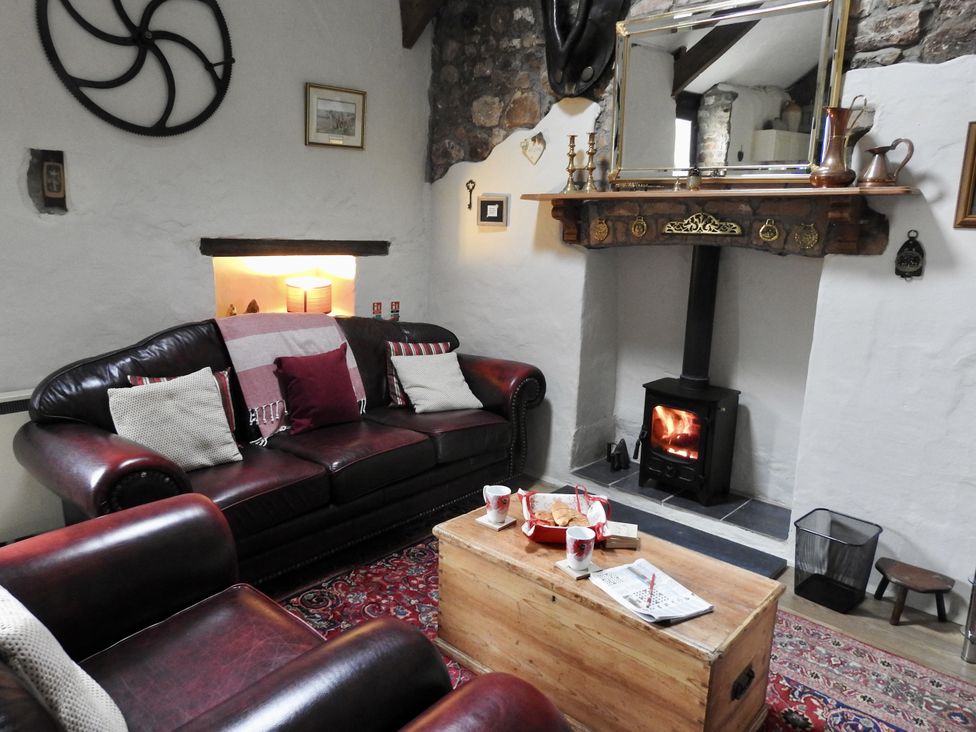A living room with a brown sofa and coffee table at Butterslade