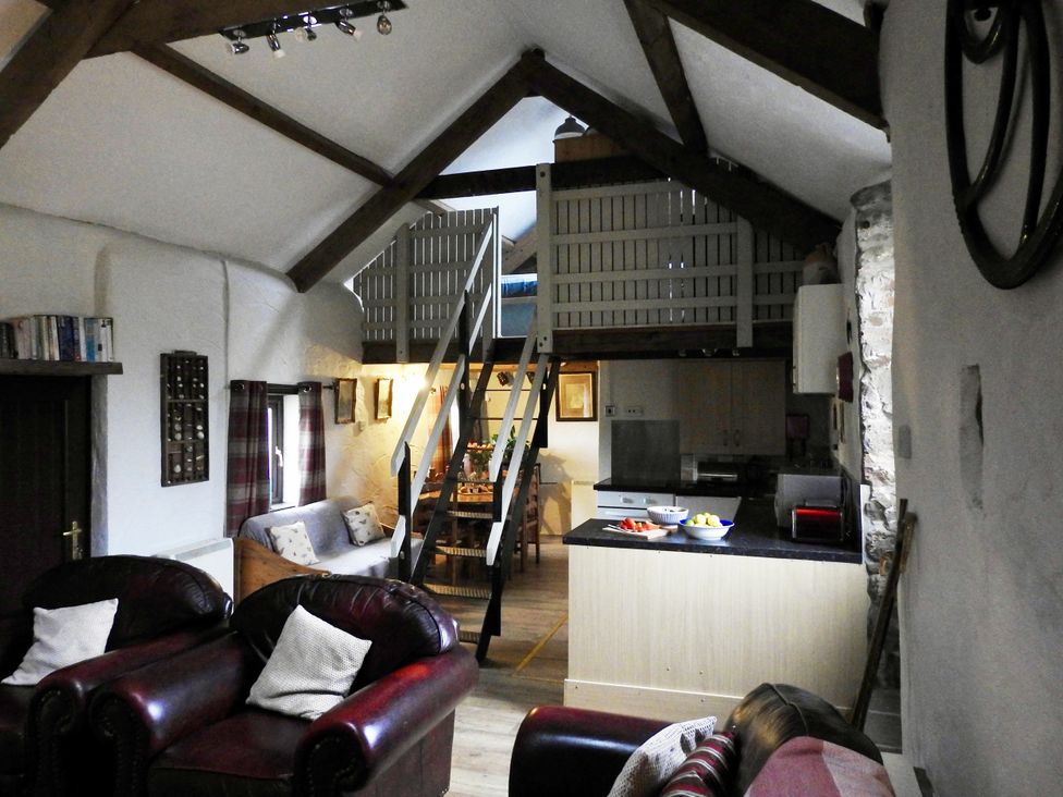 A living room with a sofa and ladder at Butterslade 
