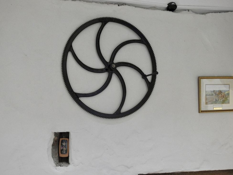 A gear on the wall and a framed picture at Butterslade