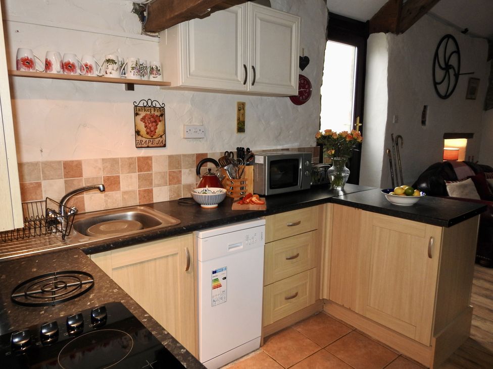 A kitchen with a sink, stove and microwave at Butterslade
