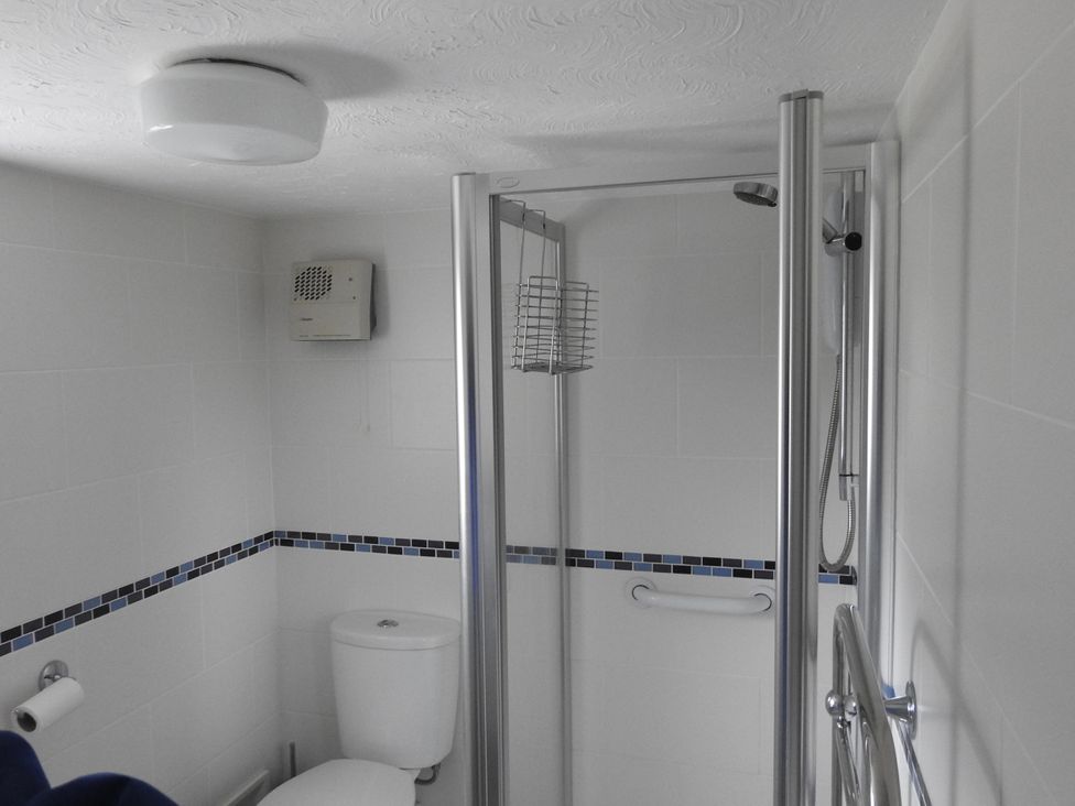 A bathroom with a shower and toilet at Butterslade