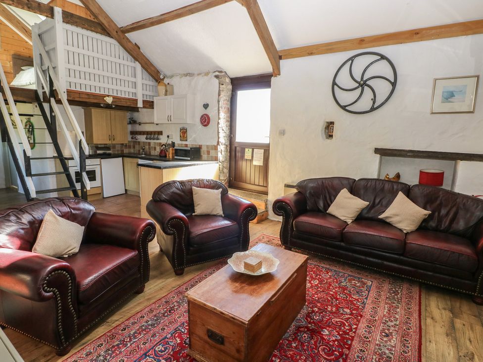 A living room with sofas and a coffee table at Butterslade in Port Eynon